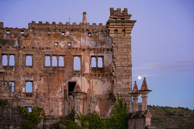 Abandoned building of termas radium spa hotel serra da pena with full moon in sortelha, portugal