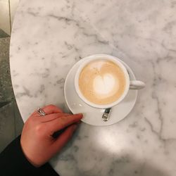 Woman holding coffee cup