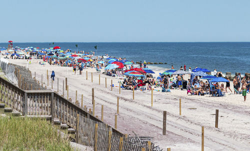 Fire island national sea shore is crowded on a hot sunday.
