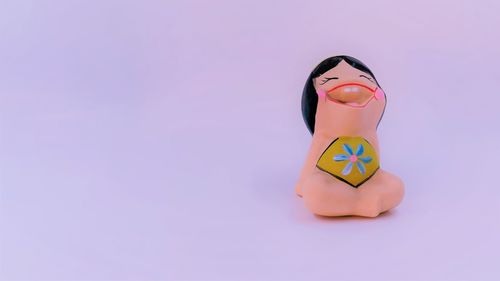 Toy figurine against pink background