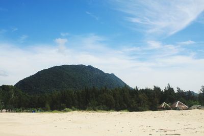 Scenic view of land and mountains against sky