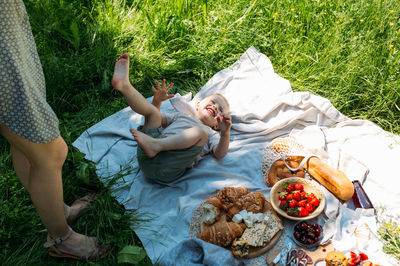 Low section of woman standing on grass