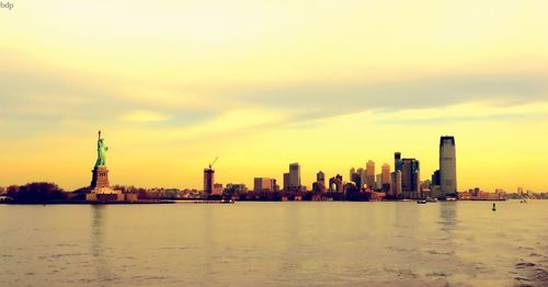 City at waterfront during sunset