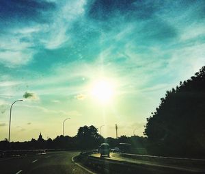 Road passing through sunset