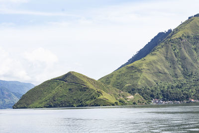 Scenic view of lake and mountains against sky