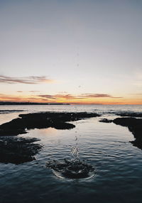 Scenic view of sea against sky at sunset