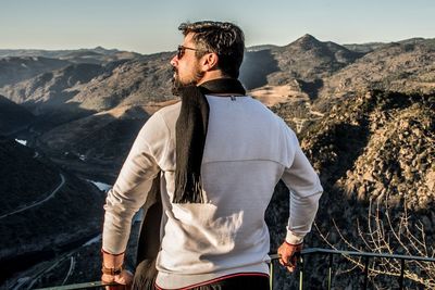 Full length of young man standing on mountain