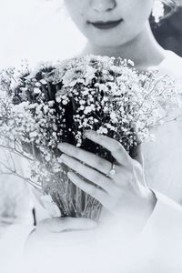 Close-up of woman holding flower bouquet