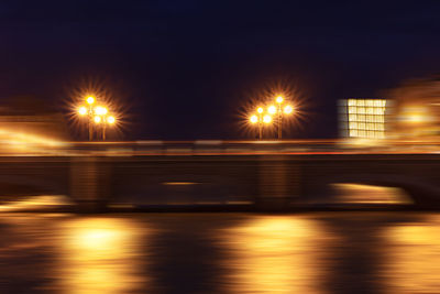 Blurred motion of illuminated bridge at night