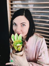 Portrait of young woman sitting at home