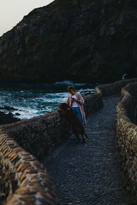 Woman on rocks at sea shore