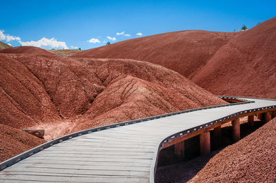 Boardwalk amidst dramatic landscape