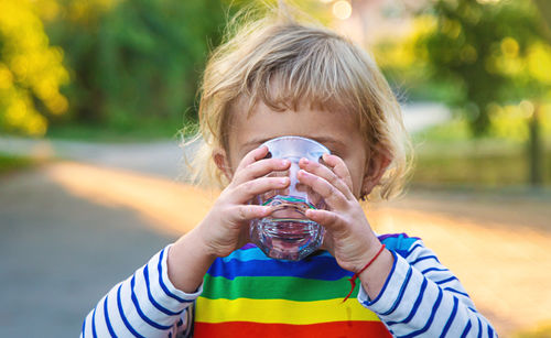 Close-up of woman drinking water from bottle