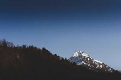 Scenic view of snowcapped mountains against clear sky