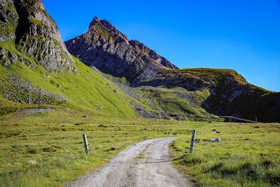 Scenic view of mountains against clear blue sky