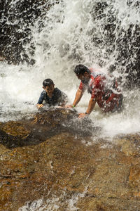 Man splashing water in sea