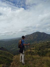 Full length of man standing on mountain against sky
