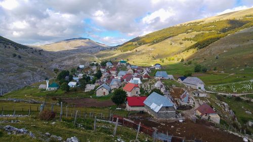 Panoramic shot of townscape by mountains against sky