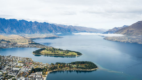 Scenic view of lake and mountains against sky