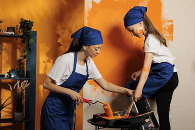 Side view of woman preparing food at home