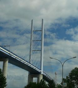 Low angle view of bridge against cloudy sky