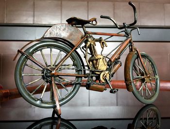 Close-up of bicycle parked against wall