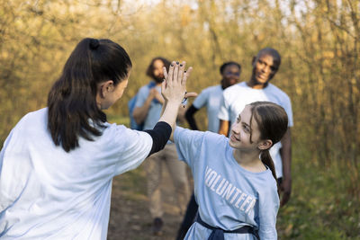 Side view of woman holding hands
