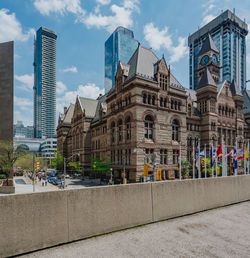 Buildings against cloudy sky