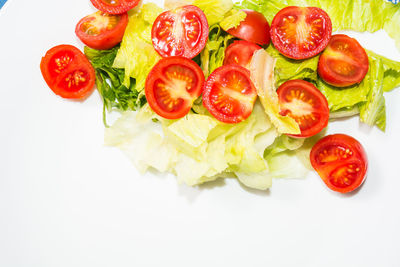 High angle view of chopped tomatoes over white background