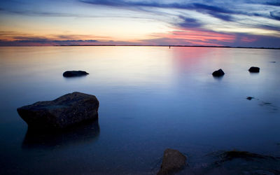 Scenic view of sea against sky at sunset