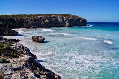 Azure water, tranquil waves on an isolated rocky coastline, along the great ocean road, australia.