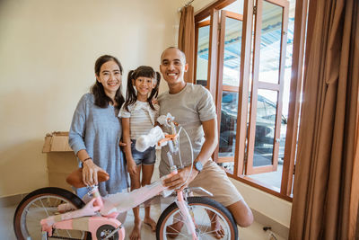 Portrait of smiling family with at home