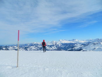 Tourists on snow covered mountain