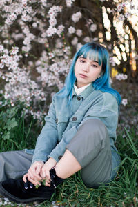 Portrait of woman sitting on field