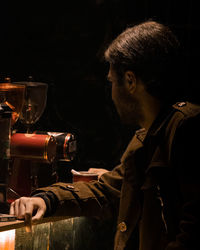 Side view of man working at workshop