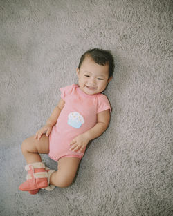 Portrait of cute baby girl against wall