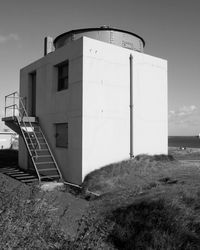 Built structure on landscape against sky