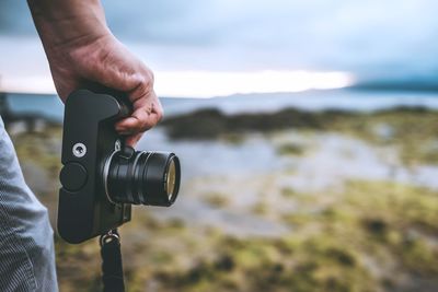 Close-up of man holding camera