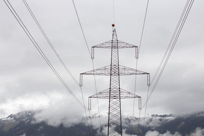 Low angle view of electricity pylon against sky