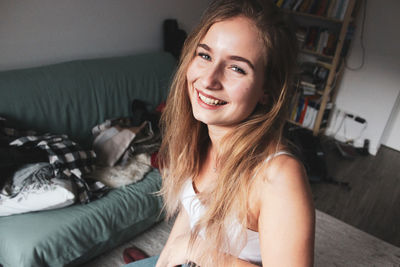 Portrait of a smiling young woman at home