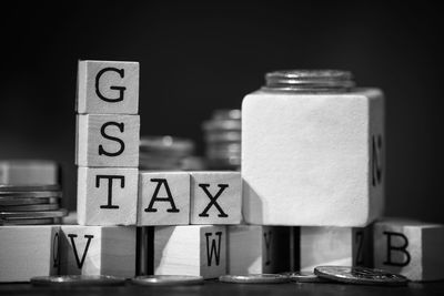Close-up of gst text on wooden blocks