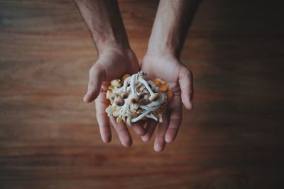 Low section of person holding ice cream on table