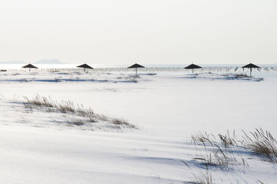 Scenic view of sea against clear sky during winter