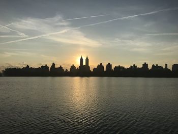 Silhouette of buildings against sky during sunset.