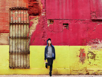 Boy standing in front of building