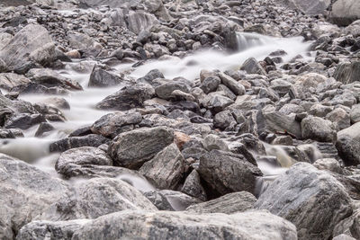 Blurred motion of stream flowing through rocks