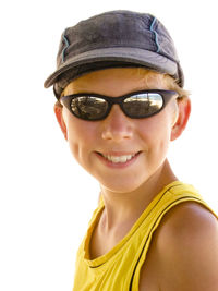 Close-up portrait of smiling boy wearing sunglasses and cap on sunny day