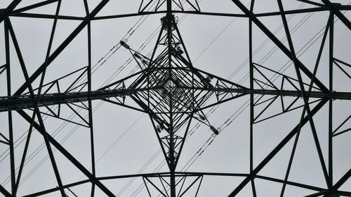 Low angle view of electricity pylon against sky