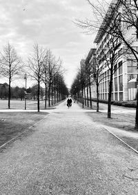 Rear view of man walking on street in city