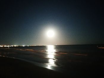 Scenic view of sea against clear sky at night